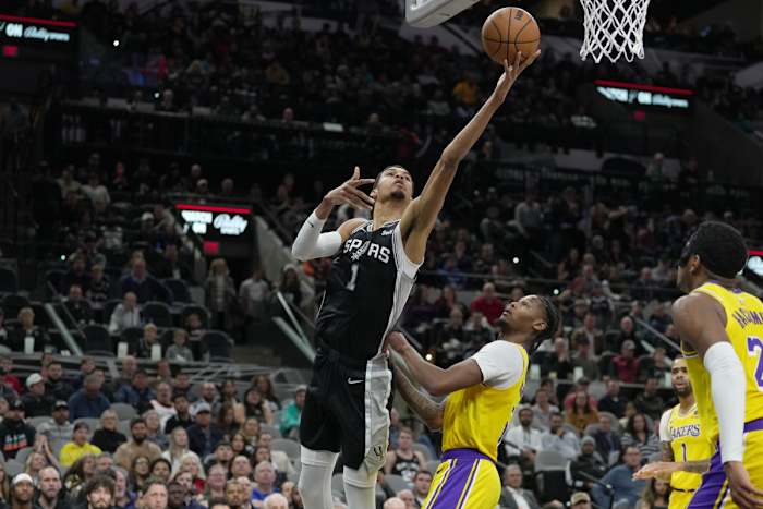 Dec 13, 2023; San Antonio, Texas, USA; San Antonio Spurs center Victor Wembanyama (1) shoots over Los Angeles Lakers forward Cam Reddish (5) in the first half at the Frost Bank Center.